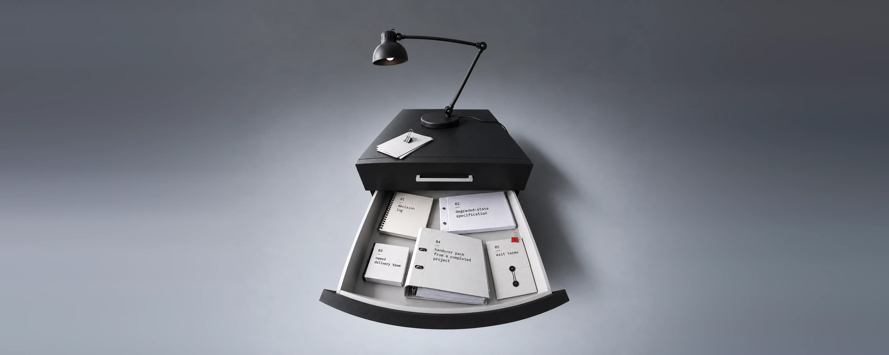 Five upright document folders in a row on a concrete surface, one black and the rest grey and white, with a single red sheet showing in one of them
